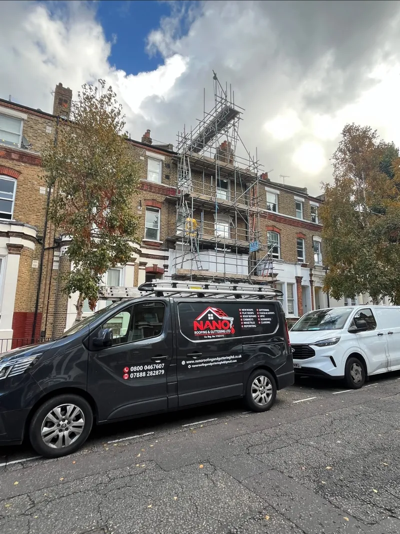 Nano Roofing & Guttering van parked below a scaffold tower on a brick terrace