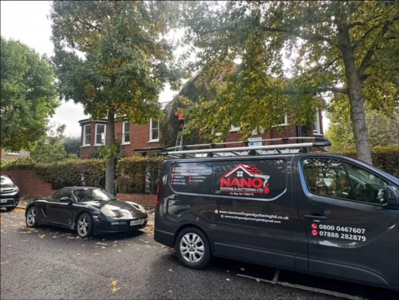 Nano Roofing & Guttering van parked on a tree-lined residential street