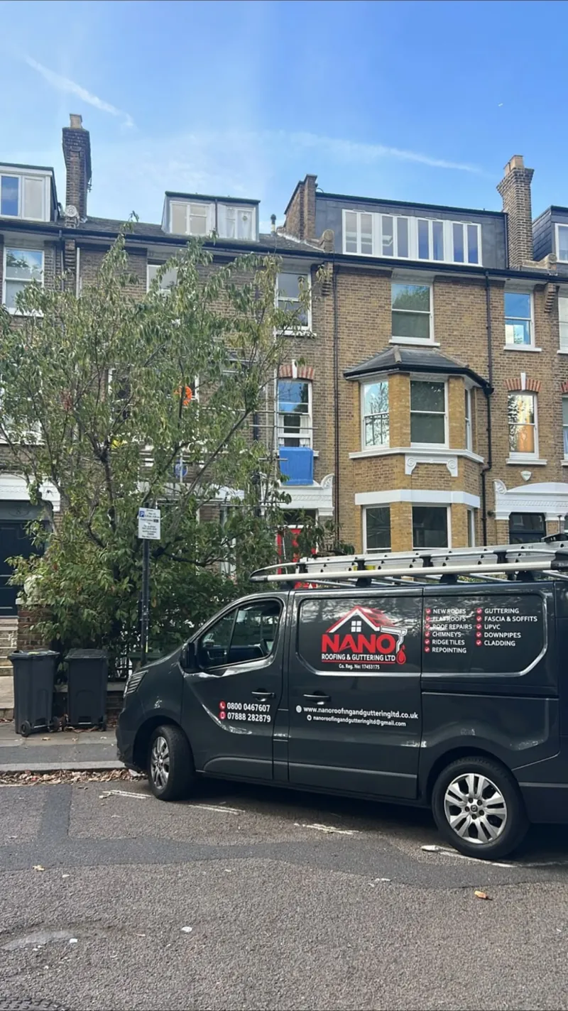 Nano Roofing & Guttering van parked outside a four-storey yellow brick terrace with bay windows