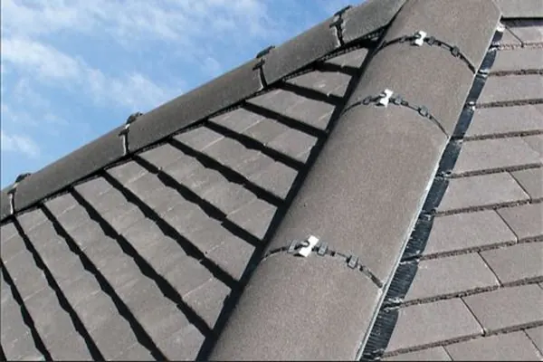 Grey ridge tiles fixed with a dry ridge system on a grey tiled roof