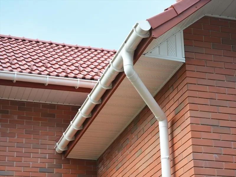 White uPVC fascia, soffit, gutter and downpipe on a red brick house with a red tiled roof