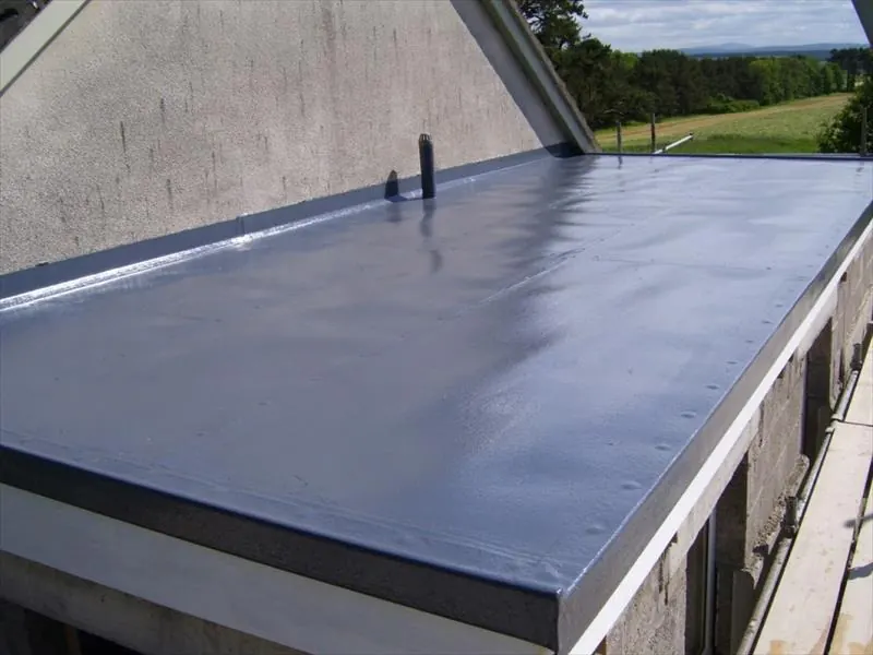 Smooth blue-grey GRP fibreglass flat roof with a trimmed edge and a vent pipe